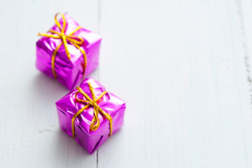 Purple gift box on white wood