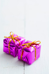 Purple gift box on white wood