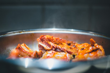 Steam over the pan from hot roasted ribs