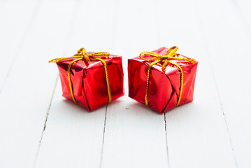 Red gift box on white wood
