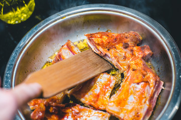 Frying pork ribs - wooden spatula