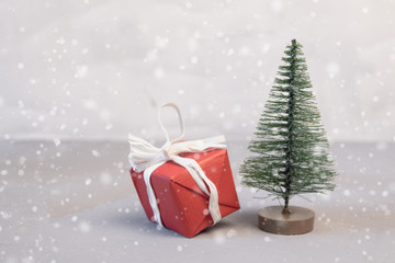 Fototapeta na wymiar Red Christmas balls,gift boxes and fir tree on snow
