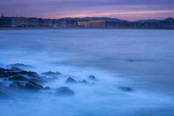 Sunset in the sea with Zurriola beach in the city of San Sebastian, Basque Country