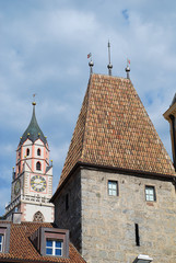 Fototapeta premium Meran, South Tyrol, Italy: St. Nicholas' Church and the Bozener Tor (Bozen Gate)