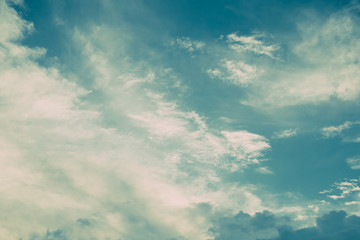 Turquoise blue and white clouds in sky. Vintage colors. For background and wallpaper