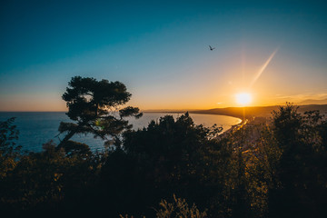 Beautiful bright saturated sunset over the promenade of Nice