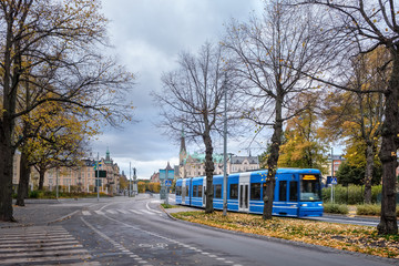Obraz premium Cityscape of Stockholm, Sweden, in autumn with blue modern tram.