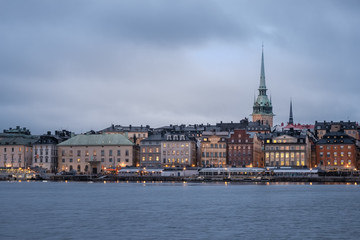 Fototapeta na wymiar Cityscape of Gamla Stan in Stockholm, Sweden, at sunset. Old city of Stockholm at sunset during blue hour.