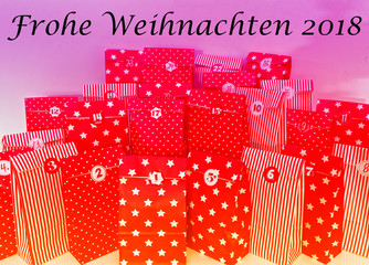 Door of an advent calendar with 24 parcels in red with in german Frohe Weihnachten 2018 in english Merry Chrstmas 2018