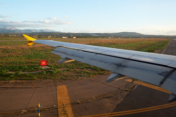 Airplane riding on takeoff strip in the airport, view from airplane window. Spain