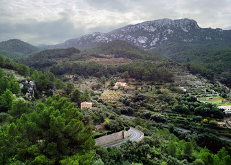 Fototapeta na wymiar Banyalbufar town surrounded by Tramuntana mountains. Majorca, Spain