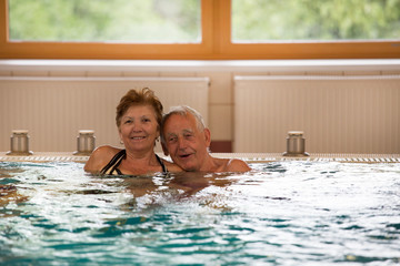Elderly couple in pool