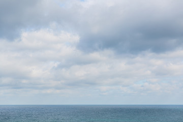 View of the sea, horizon line, clouds and blue sky. Sea water and sky horizon line