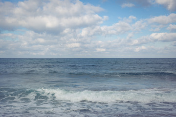 View of the sea, horizon line, clouds and blue sky. Sea water and sky horizon line