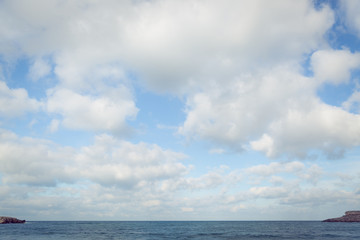 Naklejka na ściany i meble View of the sea, horizon line, clouds and blue sky. Sea water and sky horizon line