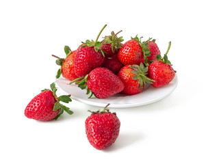 Ripe strawberries in a white plate