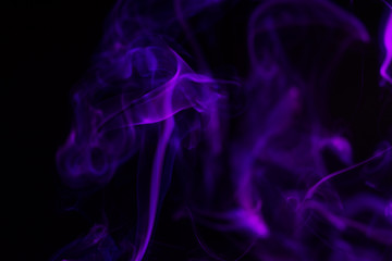 Fototapeta premium Colorful smoke close-up on a black background