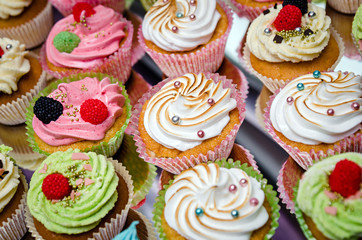 group of tasty cupcakes on a white wooden table
