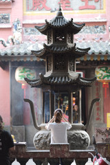 Religious building with several tiers of a roof on a round stone base. Vietnam