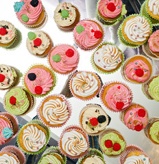 group of tasty cupcakes on a white wooden table