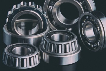 Close-up of a set of ball and roller bearings on a dark background