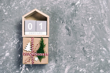 Christmas calendar 1 january. Christmas gift, fir branches on vintage, toned wooden white background. Copy space, top view