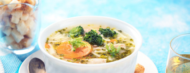 Italian vegetable soup with broccoli carrots and noodles in chicken broth