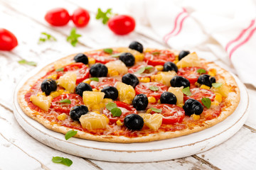 Pizza with tomatoes, mozzarella cheese, olives, corn and basil. Traditional italian cuisine
