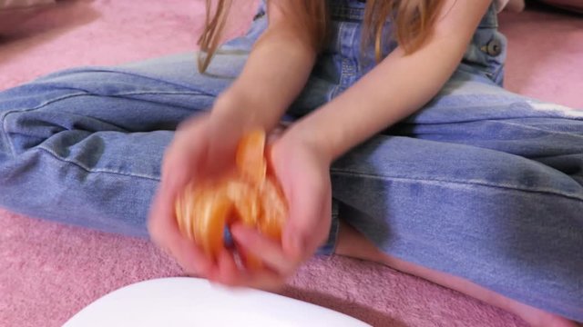 Girl wrists with mandarin slices