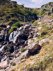 An hiking trail in the iconic Ossau valley in the french pyrennees pass by a vivid stream