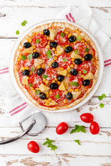 Pizza with tomatoes, mozzarella cheese, olives, corn and basil. Traditional italian cuisine. Top view