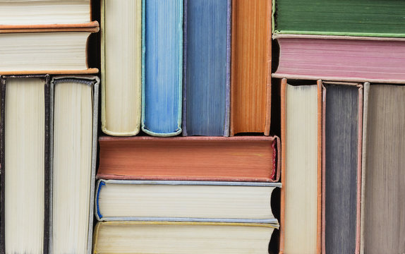 Many old books stacked in texture