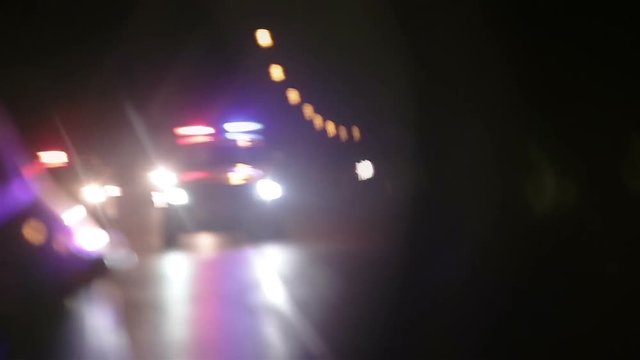 Police lights flashing in side view mirror of car