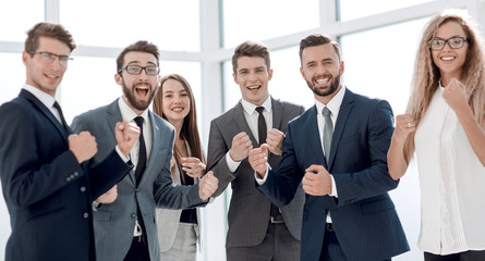 happy business team standing in office.