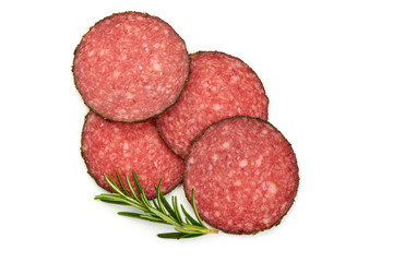 Salami sliced. Raw smoked sausage slices with herbs, isolated on a white background. Top view.