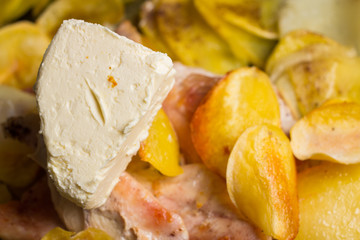 Appetizing roasted potatoes chips, with fried chicken fillet.