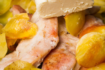 Appetizing roasted potatoes chips, with fried chicken fillet.