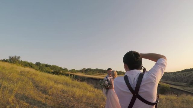 wedding photographer takes pictures of the bride and groom