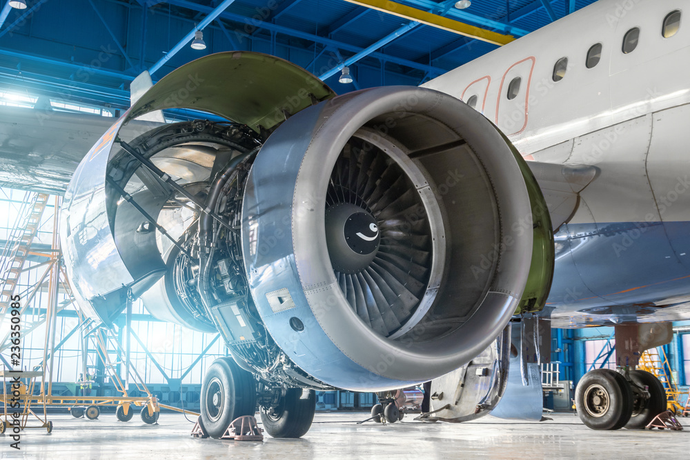 Wall mural aircraft engine jet on the wing during maintenance in the hangar.