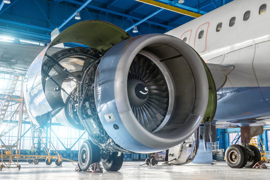 Fototapeta Aircraft engine jet on the wing during maintenance in the hangar.