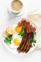 Fried eggs, sausages and cherry tomatoes