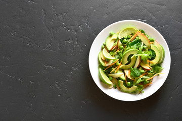 Vegetarian vegan salad with avocado, green pea, greens, apple 
