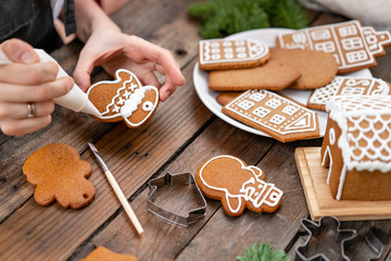 A young girl decorates ginger cookies in the