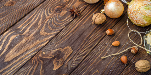 Christmas balls decor and nuts on old wood background with empty place for text