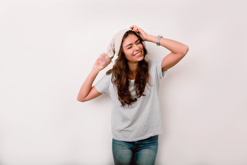 Fototapeta premium Charming girl with happy face expression posing in winter accessories. Indoor photo of enthusiastic lady hats off cap of head with expression face