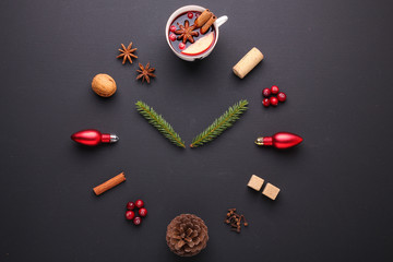 A clock in the form of spice for mulled wine. Cinnamon, anise stars, cranberries, brown sugar. Concept, creative work.