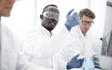 Fototapeta premium group of scientists are conducting experiments with the liquid