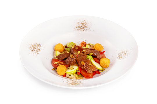 Plate of healthy meat salad with vegetables isolated at white background.