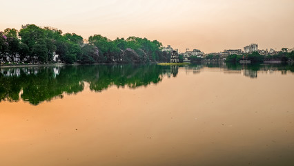 The sun setting over a lake in Hanoi, Vietnam
