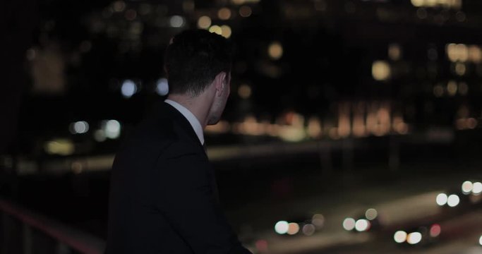 Businessman looking out at busy city